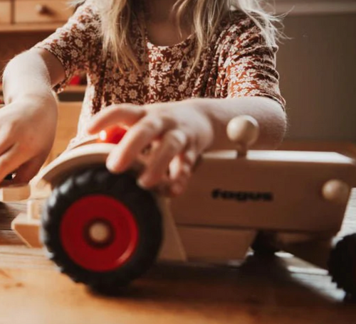 child playing with  fagus modern tractor