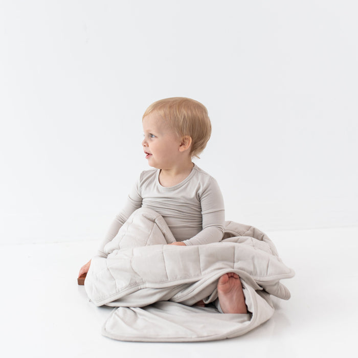 caption-child cuddles Kyte Toddler Blanket in Ecru tone