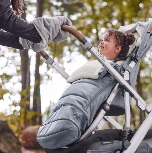 caption-Child in UPPAbaby Vista Stroller - CozyHandmuff attached to handlebar