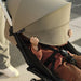 caption-Stokke YOYO3 Stroller with child playing peekaboo