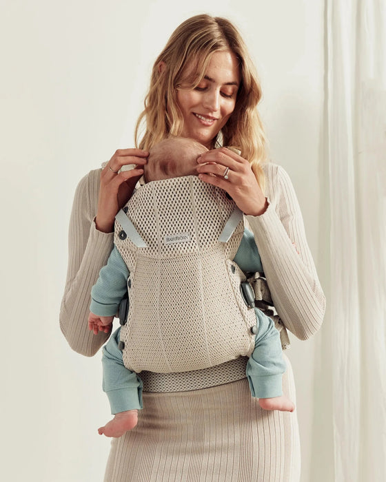 caption-Mother wearing Baby Bjorn Harmony Carrier with baby facing in