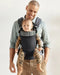 caption-Father wearing Baby Bjorn Harmony Carrier with forward facing baby