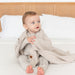 caption-Child sits with Chunky Knit Kyte Baby Blanket  in Oat