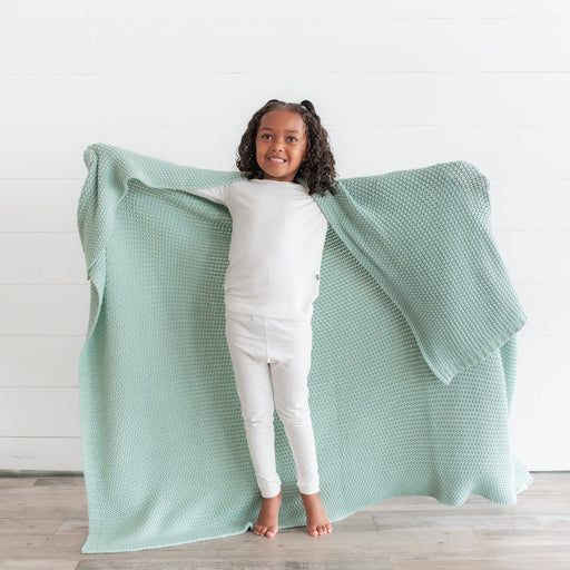 caption-Child with Kyte Baby Chunky Knit Toddler blanket