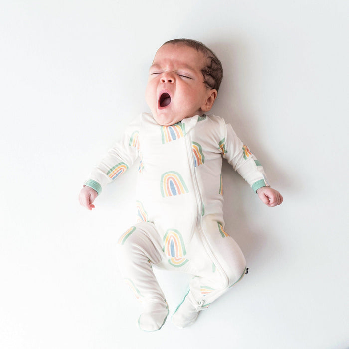 caption-Baby wearing Kyte Baby Zippered Footie in Wasabi Rainbow